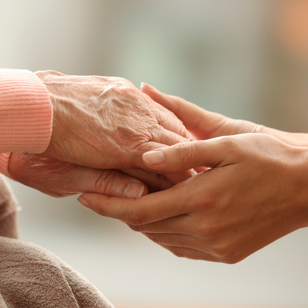 Hands with biologically old skin and hands with biologically young skin hold to each other.